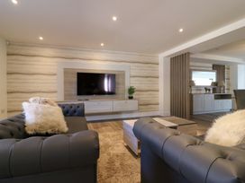 A living room with a television mounted on the wall at The Newland in Morpeth