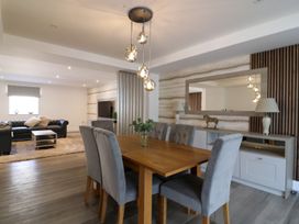 A dining room with a wooden table and grey chairs at The Newland in Morpeth