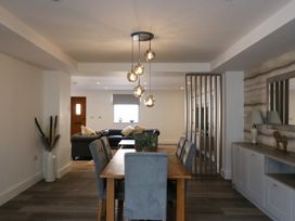 A dining room with a table and chairs overlooking a sofa at The Newland in Morpeth