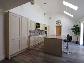A kitchen with cabinets and an island at The Newland in Morpeth