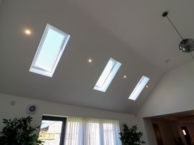 A ceiling with skylights and lights in a living room at The Newland in Morpeth