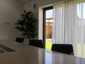 A dining room with a table, chairs, and a window at The Newland in Morpeth