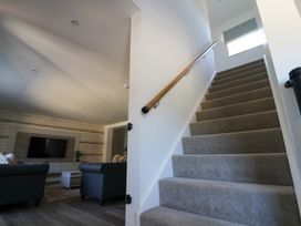 A staircase leading to an upper level with a living room in view at The Newland in Morpeth