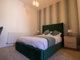 A bedroom with a bed and bedside tables at The Newland in Morpeth