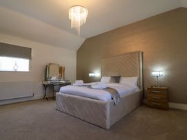 A bedroom with a bed and a mirror at The Newland in Morpeth