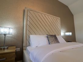A bedroom with a bed and bedside lamps at The Newland in Morpeth