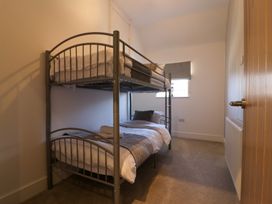 A bunk bed with linens and a cushion at The Newland in Morpeth
