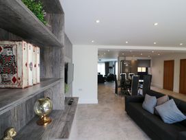 A living room with a television and dining area at The Gavel in Morpeth