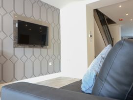 A living room with a television mounted on the wall at The Gavel in Morpeth