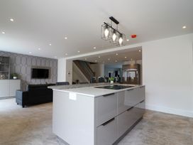 A kitchen with a central island and seating area at The Gavel in Morpeth