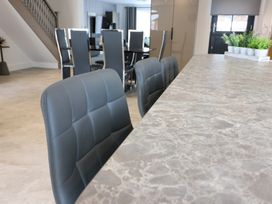 A kitchen with bar stools and a dining table at The Gavel in Morpeth