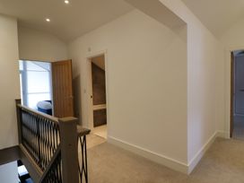 A hallway with doors and a staircase at The Gavel in Morpeth