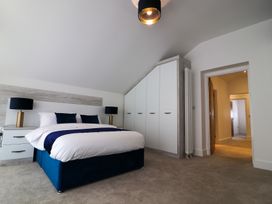 A bedroom with a bed and wardrobe at The Gavel in Morpeth