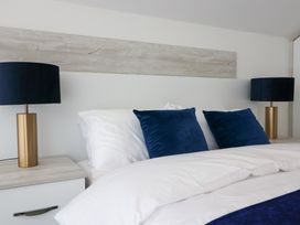 A bedroom featuring a bed with pillows and lamps at The Gavel in Morpeth