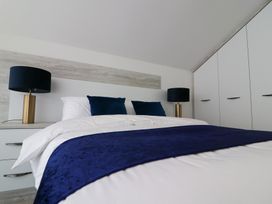 A bedroom with a bed and a lamp at The Gavel in Morpeth