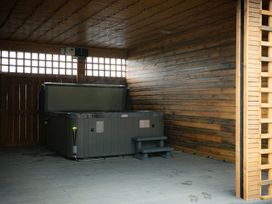 A hot tub with steps in a wooden enclosure at The Gavel in Morpeth