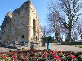 Ruins with flower bed and benches at an outdoor location