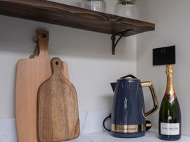 A kettle and cutting boards on a countertop at Honeysuckle Lodge Knaresborough