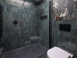 A bathroom with a shower and toilet at Honeysuckle Lodge in Knaresborough