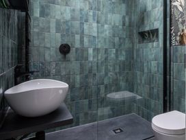 A bathroom containing a sink, shower, and toilet at Honeysuckle Lodge Knaresborough