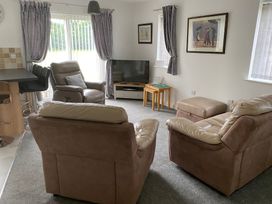 A living room with a sofa and television at 19 Carnaby Mews in Bridlington