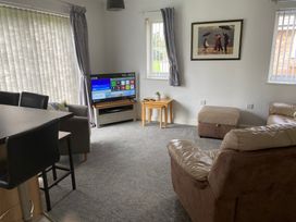 A living room with a television and sofa at 19 Carnaby Mews in Bridlington