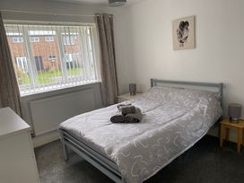 A bedroom with a bed and window at 19 Carnaby Mews in Bridlington
