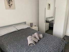 A bedroom with a bed and wardrobe at 19 Carnaby Mews in Bridlington