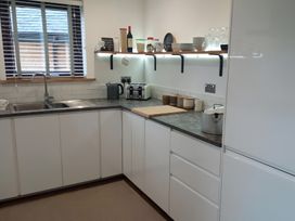 A kitchen with a sink, countertops, and appliances at Gowrie Lodge in Blairgowrie