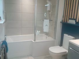A bathroom with a bathtub and shower at Gowrie Lodge Blairgowrie