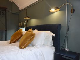 A bedroom with a bed and pillows at Ty Llaeth in Carmarthen