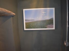 A picture frame on the wall with a landscape photograph at Ty Llaeth Carmarthen