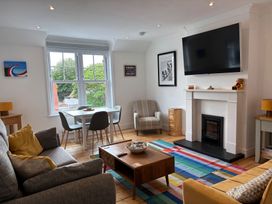 A living room with a television and seating area at Edal Court in Sheringham