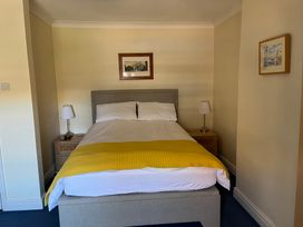 A bedroom with a bed and bedside tables at Edal Court in Sheringham