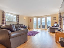 A living room with a sofa and coffee table at Groeslon Uchaf in Caernarfon