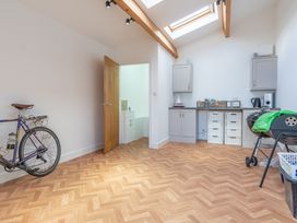 A utility room with a bicycle and kitchen cabinets at Groeslon Uchaf in Caernarfon