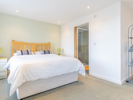 A bedroom with a bed and bathroom entrance at Groeslon Uchaf in Caernarfon