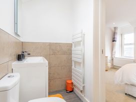 A bathroom with a toilet and sink at Groeslon Uchaf in Caernarfon
