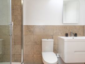 A bathroom with a shower, toilet, and sink at Groeslon Uchaf in Caernarfon