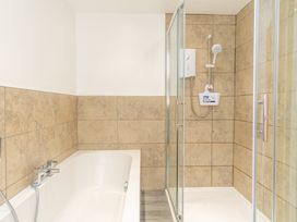 A bathroom with a bathtub and shower at Groeslon Uchaf in Caernarfon
