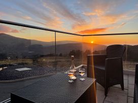 An outdoor area with glasses and a bottle at Groeslon Uchaf, Caernarfon