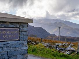 A sign for Groeslon Uchaf with mountains in the background at Groeslon Uchaf in Caernarfon
