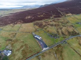 An overview of a house and surrounding fields at Groeslon Uchaf in Caernarfon