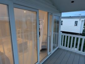 An outdoor area with doors and curtains at Lighthouse Lodge Mablethorpe