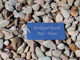 A key and tag on pebbles at Kirkapol Beach Pod - Flow Isle of Tiree