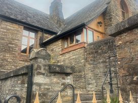 An outdoor view of a house with stone walls and windows at 4 Bickington Road Barnstaple