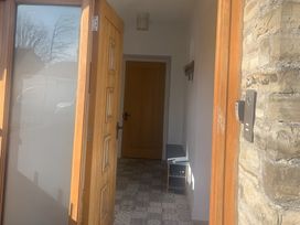 An entrance hall with a coat rack and console table at 4 Bickington Road Barnstaple