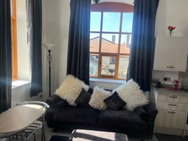 A living room with a sofa and a lamp at 4 Bickington Road Barnstaple