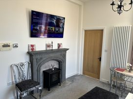 A living room with a television and fireplace at 4 Bickington Road Barnstaple