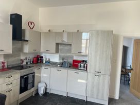 A kitchen with cabinets and appliances at 4 Bickington Road in Barnstaple